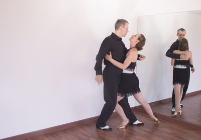 Full length of couple dancing at studio