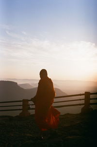 Rear view of man looking at sunset