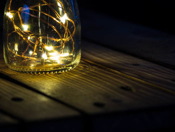 Close-up of light bulb on table