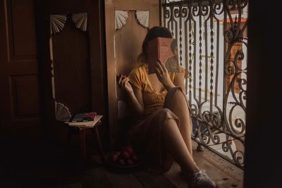 Woman sitting on chair at home