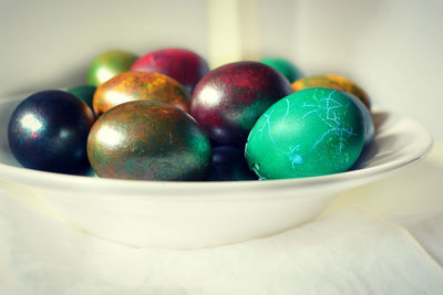 Close-up of multi colored eggs in bowl