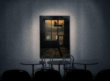 Empty chairs and table against wall at home