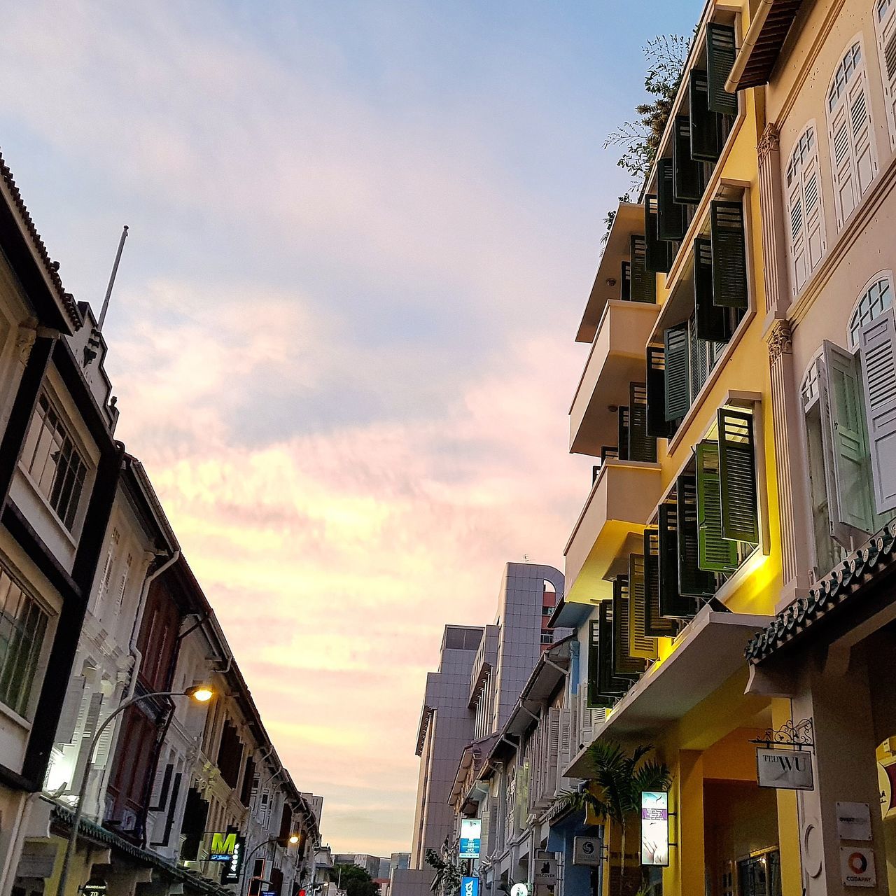 building exterior, architecture, built structure, sky, outdoors, low angle view, residential building, cloud - sky, no people, balcony, day, city, nature