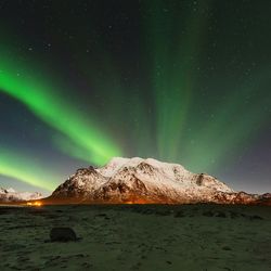 Scenic view of snowy landscape against sky at night