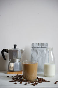 Coffee cups on table against white background