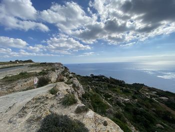 Scenic view of sea and mountains against sky