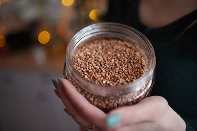 In the hands of a jar of buckwheat