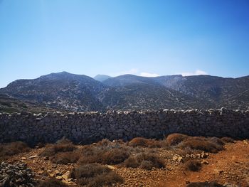Scenic view of mountains against clear blue sky