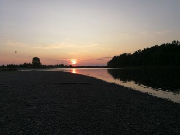 Scenic view of beach against sky during sunset