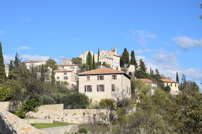 Low angle view of buildings against blue sky