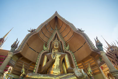 Low angle view of buddha statue in wat tham sua at kanchanaburi