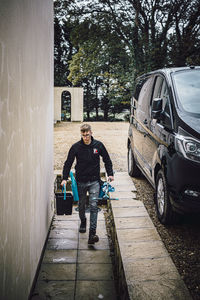 Full length portrait of man in car