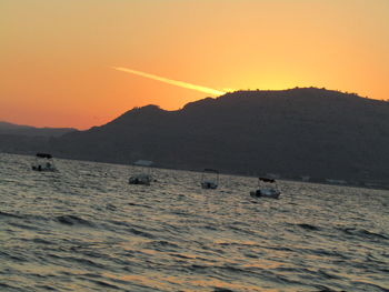 Scenic view of sea against clear sky during sunset