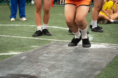 Low section of people playing at field