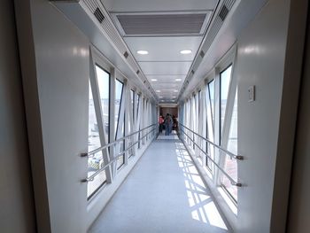 Rear view of people walking in modern building