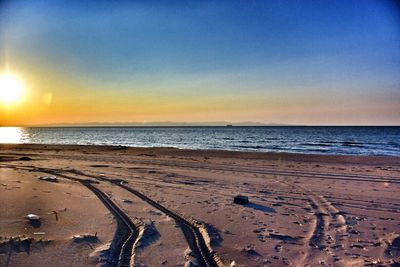 Scenic view of beach at sunset