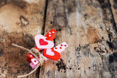 Close-up of heart shapes on clothespins on wooden table