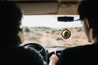 Rear view of man driving car