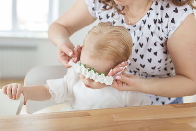 Midsection of woman holding baby