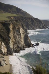 Scenic view of sea and mountains against sky