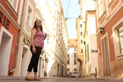 Portrait of young woman standing on street