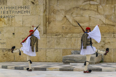 People with umbrella on wall