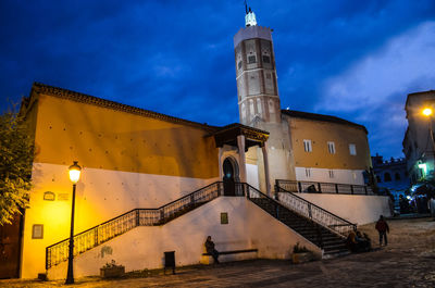 Illuminated building against sky at dusk