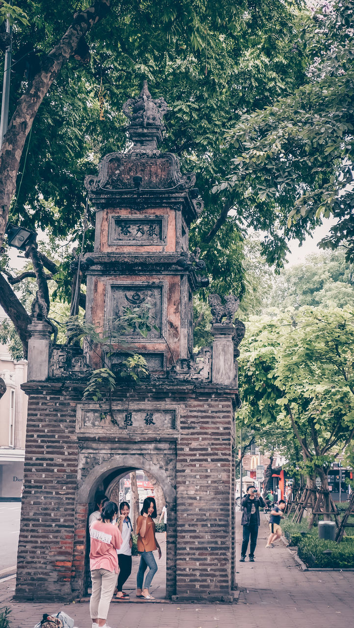 WOMAN STANDING OUTSIDE TEMPLE