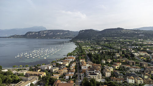 High angle view of townscape by sea against sky