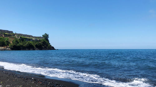 Scenic view of sea against clear blue sky