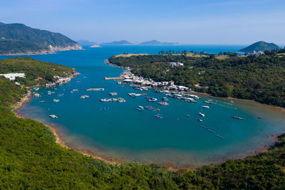 High angle view of boats on sea shore against sky