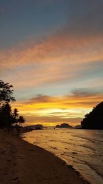 Scenic view of beach against sky during sunset