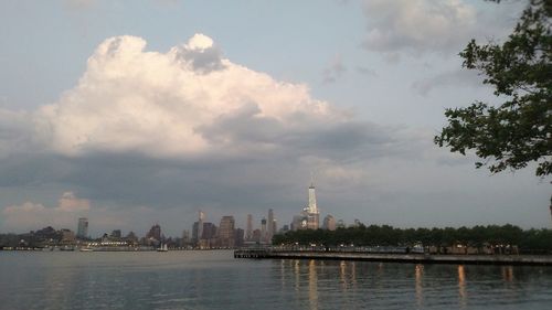 Cityscape against cloudy sky