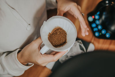 Midsection of woman holding coffee