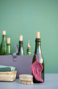 Close-up of bottles on table against wall