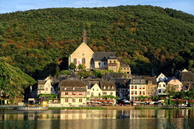 Moselle river against buildings and mountains