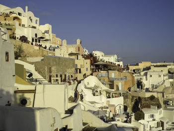 Buildings in city against clear sky