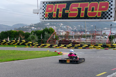 Girl riding motor vehicle on track