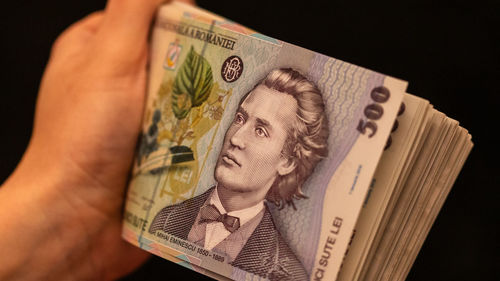 Midsection of woman holding paper currency