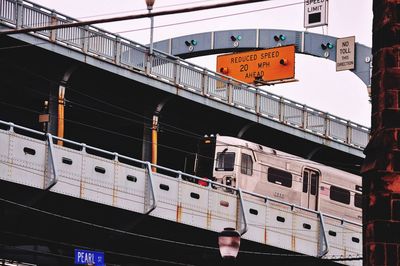 Low angle view of train on bridge in city