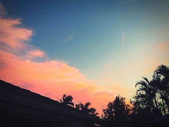 Low angle view of silhouette trees against sky at sunset