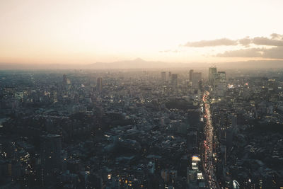 High angle view of illuminated city buildings against sky