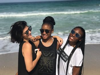 Friends standing at beach