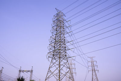 Low angle view of electricity pylon against clear sky