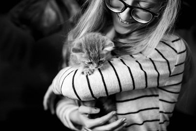 Girl holding a scottish kitten