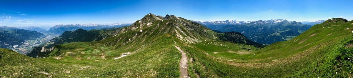 Panoramic view of green landscape against sky