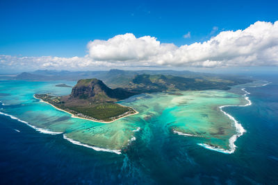 Aerial view of sea against cloudy sky