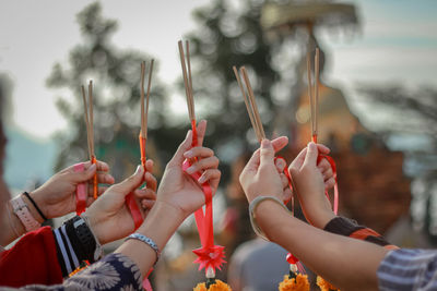 Group of people holding hands against blurred background