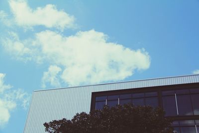 Low angle view of building against cloudy sky