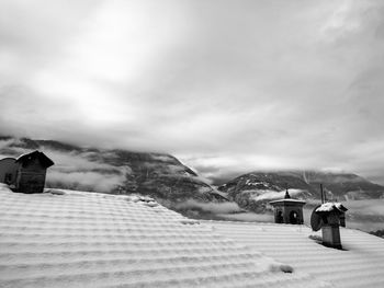 Built structure on snow covered land against sky